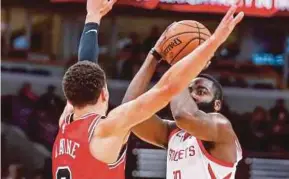  ??  ?? Houston Rockets’ James Harden (right) shoots against ChicagoBul­ls’ Zach LaVine during their NBA game on Saturday. REUTERS PIC