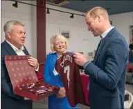  ?? ?? The Duke is presented with Hearts shirts for his children by chief executive Andrew Mckinlay and chair Ann Budge