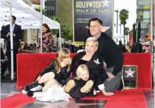  ??  ?? Recording artist Pink poses with her husband Carey and two children on her Hollywood Walk of Fame Star. — AFP photos