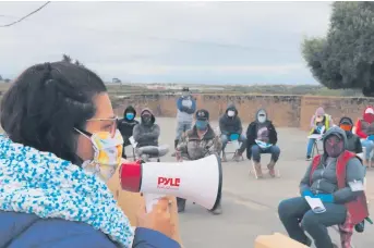  ?? - Provided photo ?? Dr. Erika Romero, a family medicine resident at Natividad, presents COVID-19 education to essential agricultur­al workers in Moss Landing.