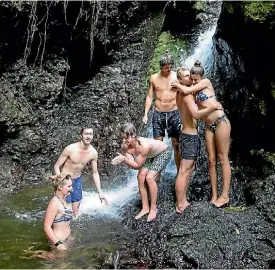  ??  ?? German tourists swimming in the waterfall at Dry Creek Valley, Belmont Regional Park.