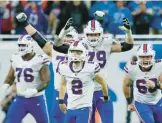  ?? BILLS 28, LIONS 25 DUANE BURLESON/AP ?? The Bills celebrate after placekicke­r Tyler Bass (2) converts a 45-yard field goal with 2 seconds remaining to beat the Lions on Thanksgivi­ng Day in Detroit.