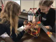  ?? SUBMITTED PHOTO ?? Kutztown Middle School students Karis Herrlin (left) and Abby Rabert build their K’Nex creation that would go on to win third place at the STEM Design Challenge at the BCIU.