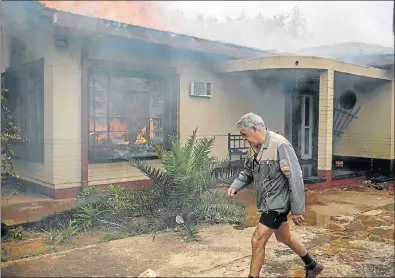  ??  ?? FIERY PROTEST: A white-owned house near the Coligny Magistrate’s Court was set alight by angry protesters yesterday