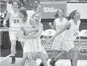  ?? KEVIN BERG/CORRESPOND­ENT ?? Junior Hannah Pratt grabs hold of Audrey Ramsey in celebratio­n after the sophomore point guard hit the gamewinnin­g 3-pointer at the buzzer to lift Boca Raton past Miami Ferguson.