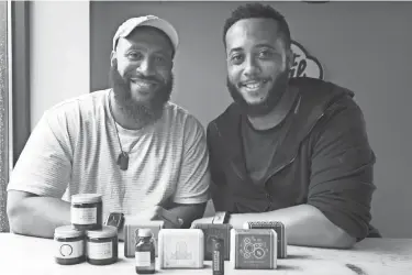  ?? JOSHUA A. BICKEL/COLUMBUS DISPATCH ?? Huckstle founders Talan Taylor, left, and Taron Taylor with some of their men’s skincare products.