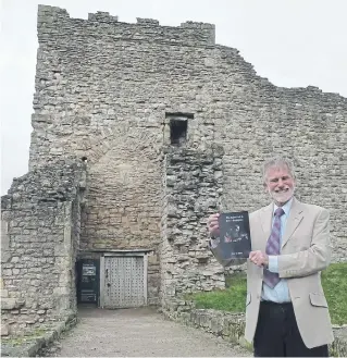  ?? ?? Historian and former teacher John Smith outside Pickering Castle which inspired his medieval stories.