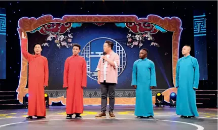  ?? ?? Rakotoariv­ony Mamisoa (second left) and Ike M. Kitili (second right) on stage with their teachers in a competitio­n show on Tianjin TV in December 2021
