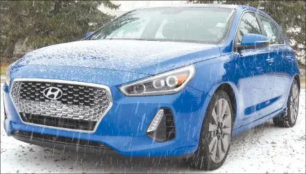  ?? Herald photos by Al Beeber ?? The 2018 Hyundai Elantra GT Sport, in its Marina Blue paint job, stands out on a snowy southern Alberta day.