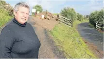  ?? PHOTO: FAIRFAX NZ ?? Briar Ross, who owns 10 Alan Murray Lane, stands on the shared driveway with 12 Alan Murray Lane.