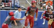  ?? THE OKLAHOMAN VIA AP ?? Division I softball is providing a training ground this season for players preparing for the Olympics. Oklahoma’s Nicole Mendes (center) will play for Mexico.