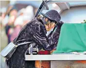  ?? ?? Shane MacGowan’s wife Victoria Mary Clarke rests her head on his coffin