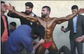  ?? WAKIL KOHSAR / AFP ?? Hares Mohammadi, 25, is covered in fake tan during a bodybuildi­ng and fitness contest in Kabul, Afghanista­n, on April 18.