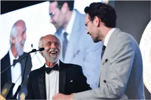  ??  ?? Eco-tourism pioneer and Lifetime of Conservati­on recipient John Rumney trades jokes with Omega’s Emir Sinanovic.