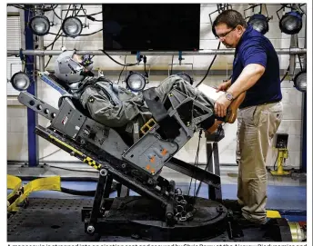  ?? FILE 2019 ?? A mannequin is strapped into an ejection seat and secured by Chris Perry at the Aircrew Biodynamic­s and Protection Facility on Wright-Patterson Air Force Base.