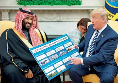  ?? AFP ?? uS President Donald trump looks at a defence sales chart with Saudi Arabia’s Crown Prince Mohammed bin Salman in the oval office of the White House on tuesday. —