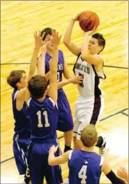  ?? MARK HUMPHREY ENTERPRISE-LEADER ?? goes airborne to get off a contested shot against Springdale Lakeside in junior high boys basketball action on Dec. 4. Lakeside defeated Prairie Grove 41-21 in the Bi-County tournament at Lincoln. Lincoln’s Dalton Lee draws the attention of four of the...