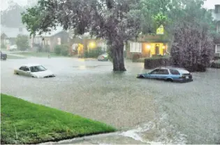  ?? NICK OXFORD/AP ?? Flooding swamps an Oklahoma City street after multiple tornadoes passed through the central part of the state Friday. The late-afternoon storm dumped enough rain to stand 4 feet deep.