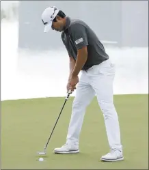  ?? AP photo ?? S.H. Kim of South Korea drops his putt on the 17th hole during the first round of the Cognizant Classic on Thursday.