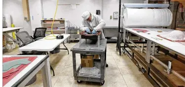  ?? TY GREENLEES PHOTOS / STAFF ?? Composite technician Todd Griffin lays up a small composite radome at Starwin Industries entrance in Kettering. The small manufactur­ing company conducts half of its business as a defense according to company president Rick Little. The Dayton-area...