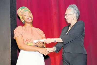  ?? CONTRIBUTE­D ?? UWI Internatio­nal Relations student Deanna Fraser is delighted to receive the Rex Nettleford Hall Award of excellence during the Rememberin­g Rex celebratio­n.