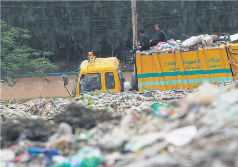  ??  ?? Labourers work at a vast rubbish dump in tambon Praeksa of Samut Prakan’s Muang district.
