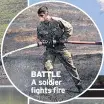  ??  ?? BATTLE A soldier fights fire