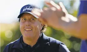  ?? CHRIS CARLSON/AP ?? Phil Mickelson smiles after his tee shot on the fourth hole during the third round of the Desert Classic golf tournament on the Stadium Course at PGA West on Saturday.