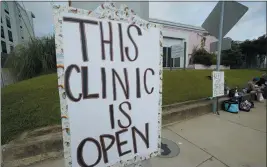  ?? ROGELIO V. SOLIS — THE ASSOCIATED PRESS ?? A posted sign outside the Jackson Women’s Health Organizati­on clinic assures potential patients that it is open Sunday in Jackson, Miss.