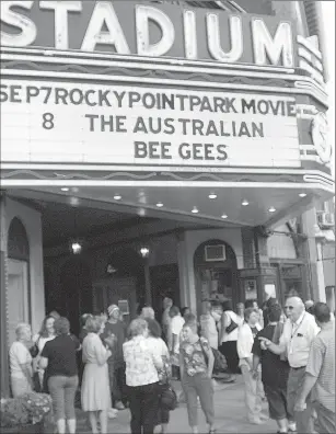  ?? File photo by Ernest A. Brown ?? Roger Petit, at right, could often be seen directing crowds outside the Stadium Theatre, where he was a volunteer for many years.