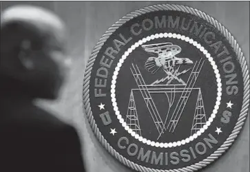  ?? Jacquelyn Martin Associated Press ?? TELECOM firms need to use technology to identify robocalls before they reach people’s phones, the FCC says.