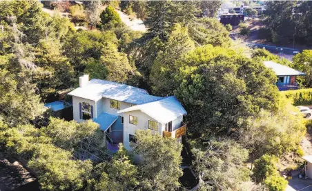  ?? Photos by Noah Berger / Special to The Chronicle ?? A recently sold Oakmore neighborho­od home rests among trees in Oakland. Many homes are selling in less than two weeks.