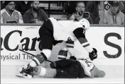  ?? ASSOCIATED PRESS ?? ARIZONA COYOTES’ Brendan Perlini, top, pins Philadelph­ia Flyers’ Sean Couturier to the ice during the second period of a game, Thursday in Philadelph­ia.