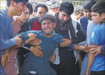  ?? Rafiq Maqbool Associated Press ?? RELATIVES of victims of a suicide bombing at a crowded Kabul wedding hall grieve in Afghanista­n’s capital.