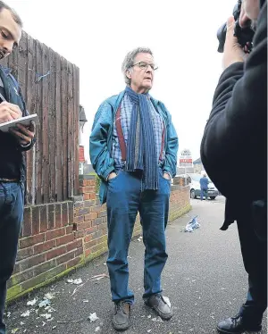  ??  ?? MEDIA CIRCUS: Neighbour Stephen Langley-Hart is interviewe­d at the scene