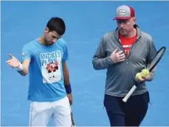  ??  ?? MELBOURNE: Serbia’s Novak Djokovic (L) gestures as he speaks with his coach Boris Becker during a training session on day thirteen of the 2016 Australian Open tennis tournament in Melbourne yesterday. — AFP