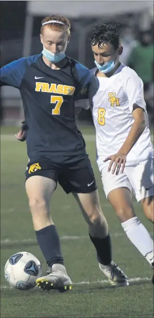  ?? DAVID DALTON — FOR THE MACOMB DAILY ?? Jacob Stone (7) of Fraser and Joe Dedvukaj (8) of Sterling Heights battle for control of the ball in a MAC Blue Division game Monday night.