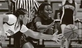  ??  ?? Loghan Johnson, left, and Jakiya Thompson fight for the ball. Johnson had eight rebounds for Tompkins, which faces Shadow Creek in the regional semifinals.