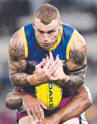  ?? Picture: BRADLEY KANARIS/GETTY ?? STRONG LEAD: Brisbane’s Mitch Robinson grabs a mark under pressure against Collingwoo­d at the Gabba in Brisbane last night.