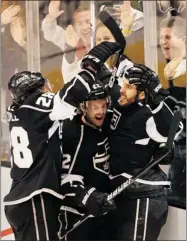  ?? ALLEN J. SCHABEN LOS ANGELES TIMES ?? The Kings’ Jarret Stoll (left) and Trevor Lewis (centre) celebrate with Dwight King after King scored against Blues goalie Brian Elliott in the second period of Game 3 Thursday.