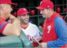  ?? LAURENCE KESTERSON — THE ASSOCIATED PRESS ?? Interim Phillies manager Rob Thomson, right, gets a laugh from first base coach Paco Figueroa, center, before Saturday’s game against the Los Angeles Angels.