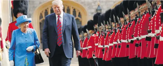  ??  ?? The Queen and U.S. President Donald Trump inspect the Guard of Honour at Windsor Castle on Friday, where they had tea together.
