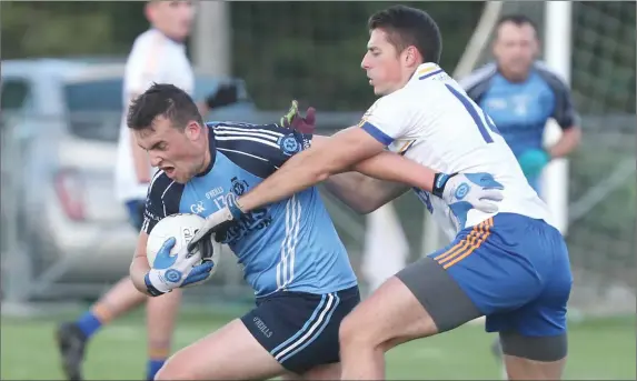  ??  ?? David O’Byrne (St Colmcille’s) wriggles clear of the challenge of Ratoath’s Gavin McGowan.