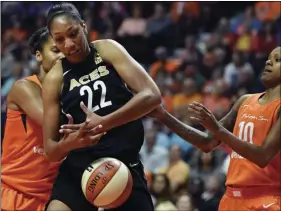  ??  ?? In this May 20, 2018, file photo, Las Vegas Aces forward A’ja Wilson (22) tries to get a rebound between Connecticu­t Sun forward Alyssa Thomas (left) and guard Courtney Williams during a WNBA basketball game in Uncasville, Conn. SEAN D. ELLIOT/THE DAY VIA AP