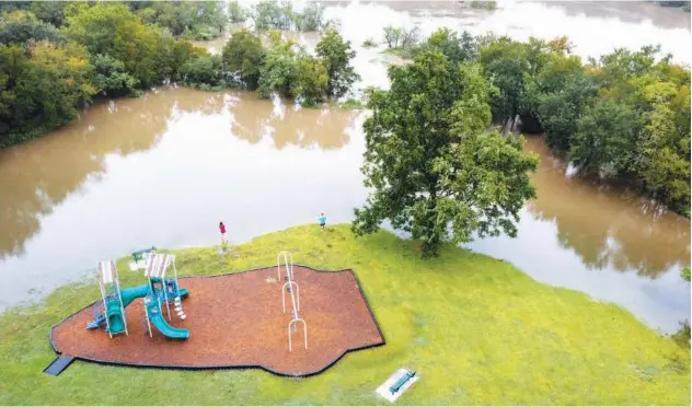  ?? Reuters ?? ↑
Residents fish in flood waters surroundin­g a neighbourh­ood in the aftermath of Hurricane Nicholas in League City, Texas, on Tuesday.