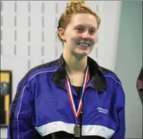  ?? THOMAS NASH — DIGITAL FIRST MEDIA ?? Phoenixvil­le’s Maddie Cooke takes the medal stand sporting her bronze medal after posting a 23.92at the District One Swimming Championsh­ips on Thursday.