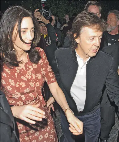  ??  ?? Sir Paul with wife Nancy, above, and, right, with Woody Harrelson on the Grammys party circuit