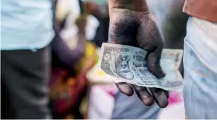  ?? — Bloomberg ?? India’s rupee was Asia’s only gainer this month, even as regional currencies dwindled in the face of a Federal Reserve interest-rate increase as early as Wednesday.