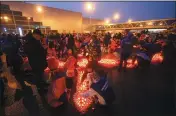  ?? SERGEI VEDYASHKIN, MOSCOW NEWS AGENCY VIA AP ?? People light candles and lay flowers at a makeshift memorial in front of the Crocus City Hall on the western outskirts of Moscow on Sunday.