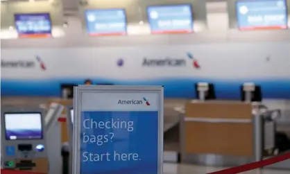  ??  ?? The American check-in desk at Dallas-Forth Worth airport. The five airlines are pushing for a $50bn-plus bailout package to help them deal with the economic effects of the coronaviru­s. Photograph: Tom Pennington/Getty Images